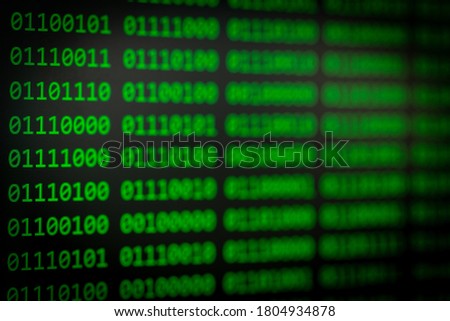 Close up of green binary code on black screen with vignetting
