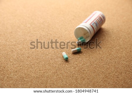Opioid drugs on a wooden table top. This image can be used to represent drug addiction. 
