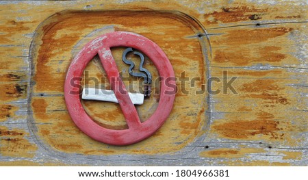 Symbol of prohibition of smoking on old wooden planks