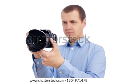 portrait of male photographer or videographer taking photo or shooting video with modern dslr camera isolated on white background
