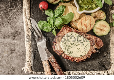 Grilled steak with herbs butter, grilled vegetable with garlic