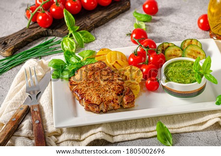 Grilled steak with herbs sauce, grilled vegetable with garlic