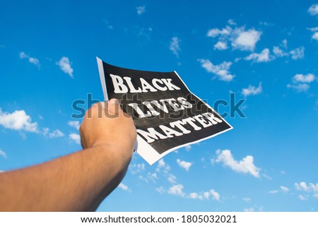 A protestor holds a banner with " Black lives matter" message. Black Lives Matter march in Washington DC.