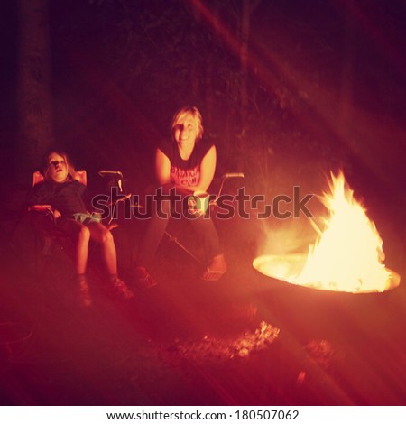 Girls having a campfire in night - Instagram effect
