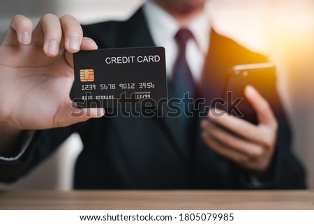 Businessman holding credit card and smartphone, businessman doing business Online shopping payment via Internet Banking, Concept digital internet Links from all over the world Internet payments.
