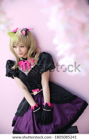 Portrait of game costume girl in pink room background