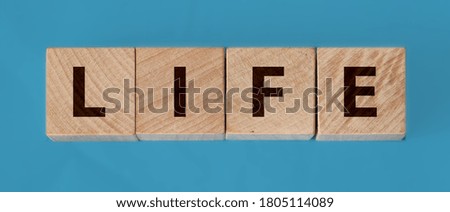 wooden cube whit the inscription Life, with on background. Safe life. Protection of life.