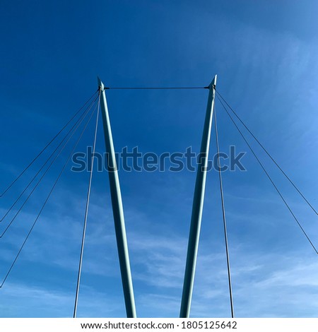 A perfectly centered picture of two suspension poles of the bridge above river lune. 