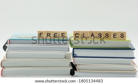 Free classes words written on wood block. Free classes text on books on white background