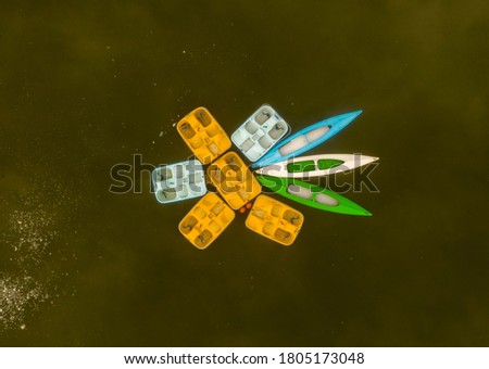 pedal boats and canoes moored in the middle of the lake - view from the drone