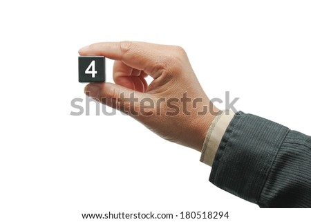 Hand with black number square dice, isolated on white.