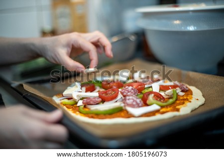 hands of woman preparing pizza at home