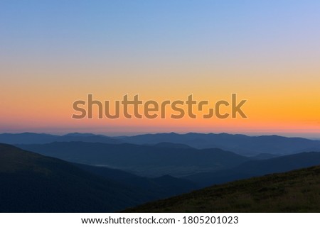 The first or last rays of the sun on a mountain pass. Morning and evening in nature. Colorful sunset and sunrise over the mountain hills. Carpathians in summer and autumn Royalty-Free Stock Photo #1805201023