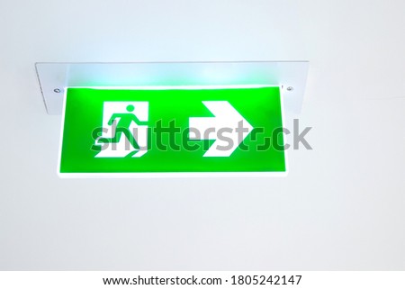 Green emergency fire exit sign or fire escape with the doorway in the building Ideas for evacuation drills in the event of a fire.