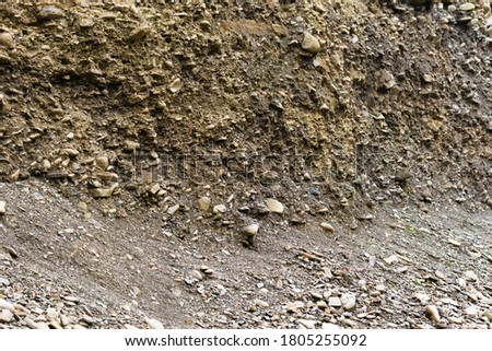 Landslide in the village. Rocks and ground are destroyed. Sunny weather. Plants die. Cataclysms. The texture of the stones. Rockfalls. Mud. Destroyed rural road landslide damaged in powerful flood Royalty-Free Stock Photo #1805255092