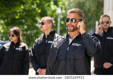 Security Guard Event Service. Officer And His Group Royalty-Free Stock Photo #1805269951