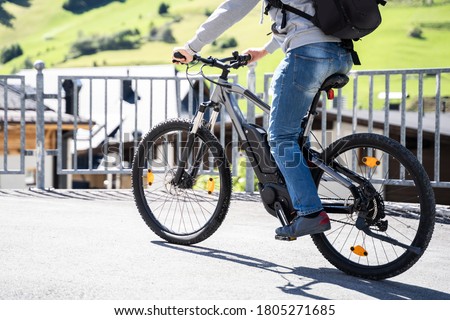 Man Riding E Bike Bicycle In City. Electric Bike In Summer