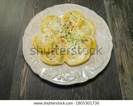 Baked ricotta cheese filled ravioli with creamy Alfredo sauce and melted cheese.