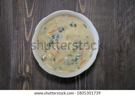 Top view of a bowl of gnocchi soup.