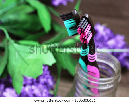 Pink and green toothbrush with beautiful flowers. Healthcare object.