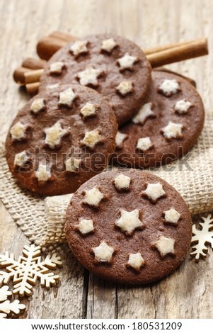 Round chocolate cookies decorated with icing stars