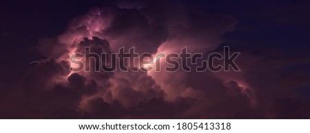 Panorama Dark cloud at  night with thunder bolt. Heavy storm bringing thunder, lightnings and rain in summer.