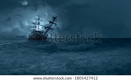 Sailing old ship in storm sea on the background heavy clouds with lightning Royalty-Free Stock Photo #1805427412