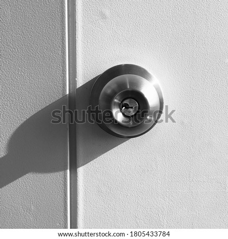 Close-up white wood pane door closed and silver knob lock in industrial building house