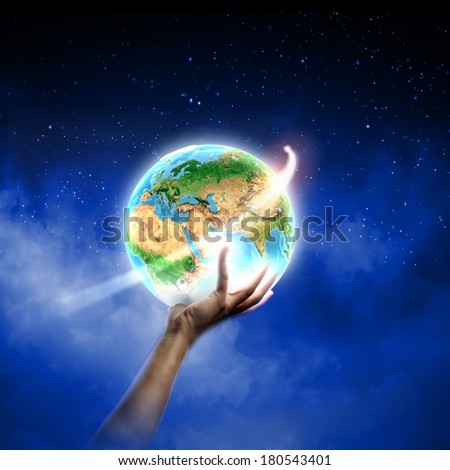 Close up of human hand holding Earth planet. Elements of this image are furnished by NASA