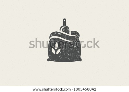 Silhouette sack of wheat flour with scoop designed for grain farming industry hand drawn stamp effect vector illustration. Grunge texture for packaging design or label decoration. Royalty-Free Stock Photo #1805458042