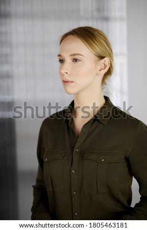 Friendly adult casual dressed business woman or student girl standing straight. Business headshot or portrait in office