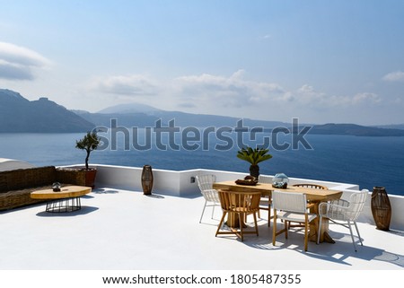 Outside table and chairs in Immerovilgi on Santorini Royalty-Free Stock Photo #1805487355