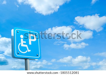 Handicap parking sign with blue sky with cloudy backgriound