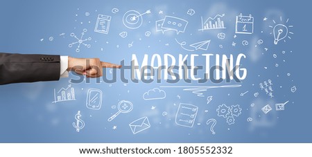 Close-Up of cropped hand pointing at MARKETING inscription, modern business solution concept