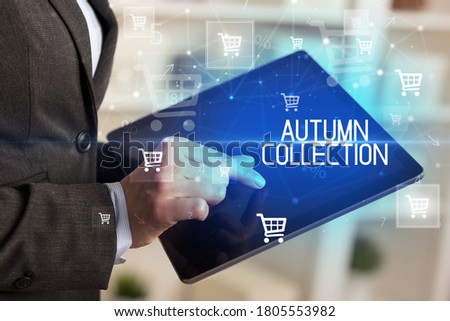Young person makes a purchase through online shopping application with AUTUMN COLLECTION inscription