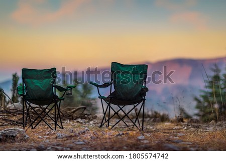 Two Empty Camping Chairs Standing on the Top of the Mount. Perfect Place for Watching Sunset. Actice Relaxation Lifestyle