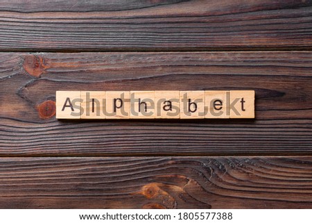 alphabet word written on wood block. alphabet text on cement table for your desing, concept.