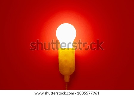 glowing light bulb on red background