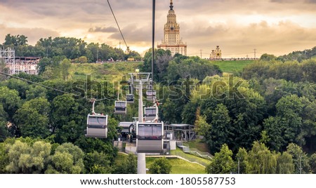 Landscape of Moscow at sunset, Russia. Scenic panoramic view of cable car and Moscow State University on Sparrow Hills. Cableway cabins move over park in summer. This place is landmark of Moscow city. Royalty-Free Stock Photo #1805587753