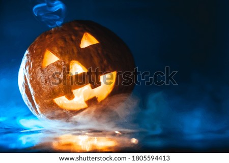 glowing pumpkin in smoke on a dark background. halloween concept. jack-o-lantern. copy space.