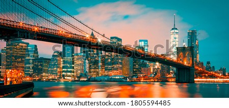 Panoramic view of New York City Manhattan midtown at dusk with Brooklyn Bridge