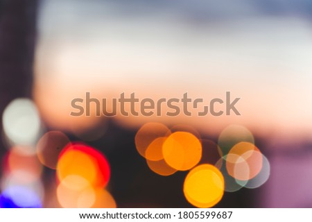 Close up picture of defocused lights on the street, as background of evening sunset view. Defocused Kyiv silhouette, Ukraine. Colorful bokeh lights of night city as wallpaper.