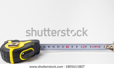 Measuring roulette yellow black on a white background banner with space for text. A construction tool tape measure