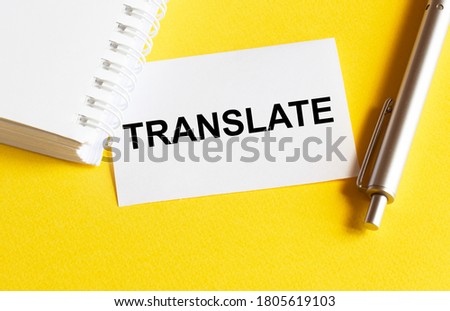 white paper with text Translate on a yellow background with stationery