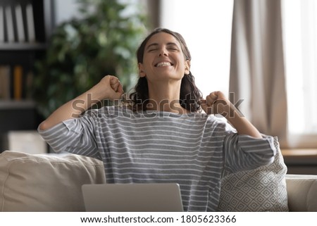 Head shot overjoyed excited young attractive woman received good news message notification on computer. Emotional positive millennial girl celebrating online success, winner victory concept.