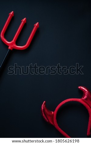 Halloween house decorations,Red Horn and trident on a black background.
