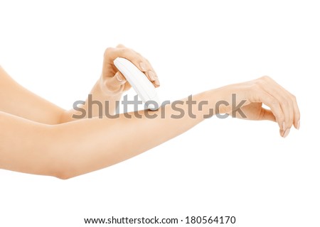A picture of a young woman removing hair from her arms over white background