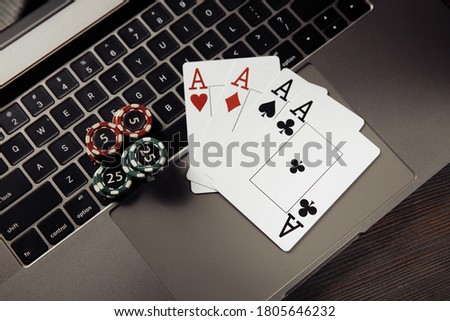 Gambling chips and playing cards on keaboard. Online casino concept