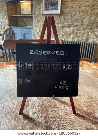 Black board easel notice on restaurants table saying reserved copy space