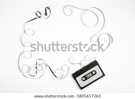 Analogue cassette tape on white background, 80s retro frame, lot of empty copy space. 